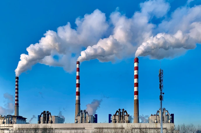 white and red industrial chimney under blue sky